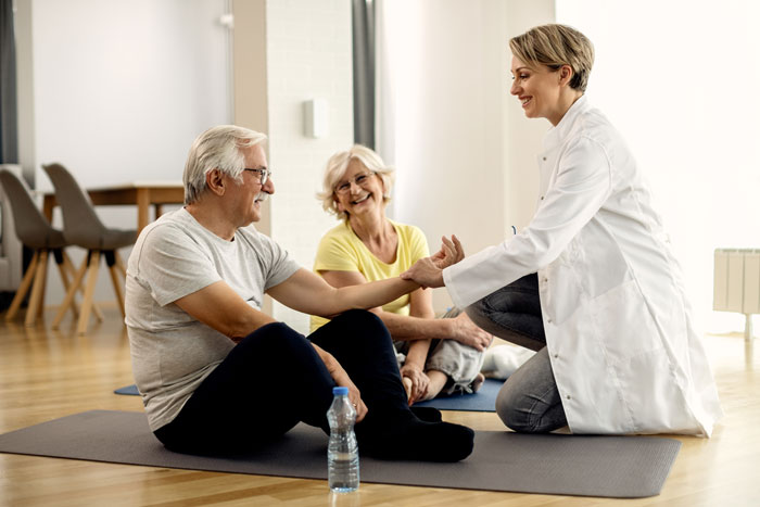 Home physical therapy with a smiling man and woman at their home